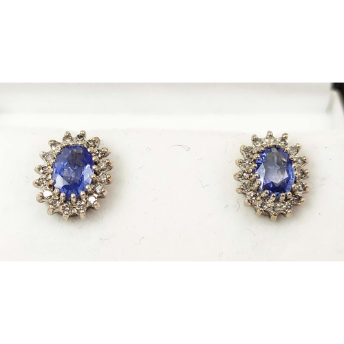 163 - A PAIR OF 9CT WHITE GOLD OVAL SAPPHIRE AND DIAMOND STUD EARRINGS, probably mid 20th century, the ova... 