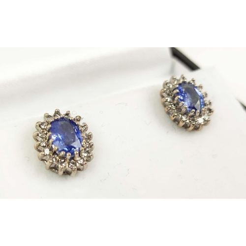 163 - A PAIR OF 9CT WHITE GOLD OVAL SAPPHIRE AND DIAMOND STUD EARRINGS, probably mid 20th century, the ova... 