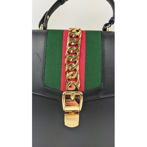 81 - GUCCI SYLVIE BAG, black leather with iconic web stripes and gold tone chain detailing on front flap,... 