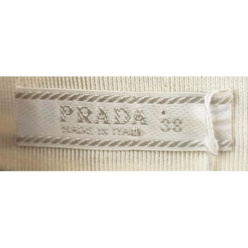 9 - PRADA PLEATED SKIRT, off white silk crepe with rows of 'Prada' lettering and logo throughout, unline... 