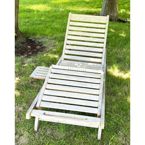 143 - GARDEN LOUNGER BY LINDSEY, well weathered teak slatted and hinged with wheels, drinks tray and cushi... 