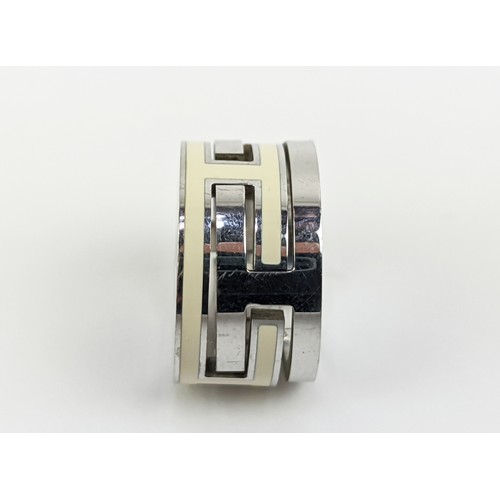 174 - A HERMES MOVE RING, sterling silver and enamelled ring size 'I', complete with box.