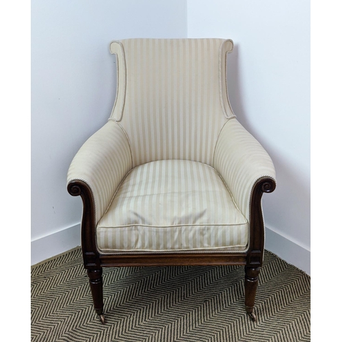 178 - LIBRARY BERGERE, Regency style mahogany in cream striped fabric on brass castors, 95cm H x 71cm.