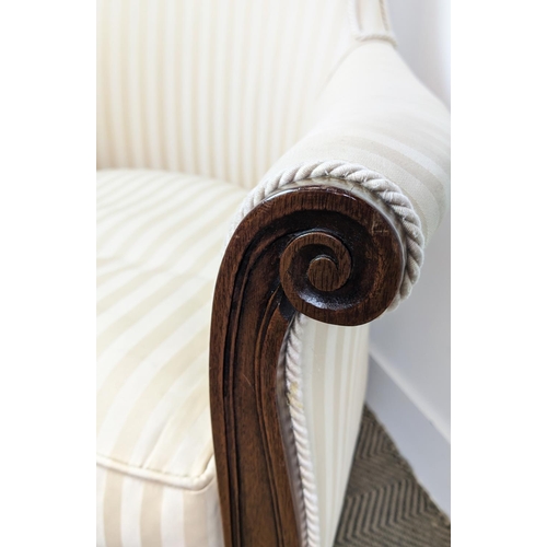 178 - LIBRARY BERGERE, Regency style mahogany in cream striped fabric on brass castors, 95cm H x 71cm.