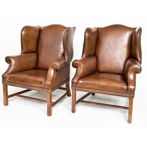 109 - WINGBACK ARMCHAIRS, a pair, George II style mahogany with hand finished brass studded antique soft b... 