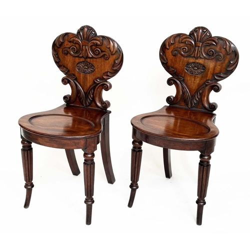 114 - HALL CHAIRS, a pair, Regency mahogany each with carved backs above oval recessed panel seats and out... 