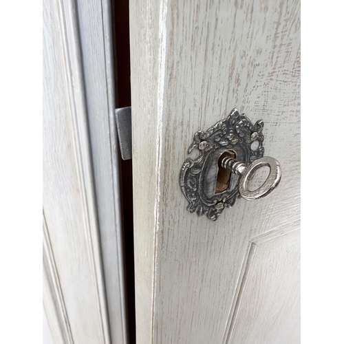 122 - ARMOIRE, French style traditionally grey painted with single panelled door, enclosing hanging above ... 