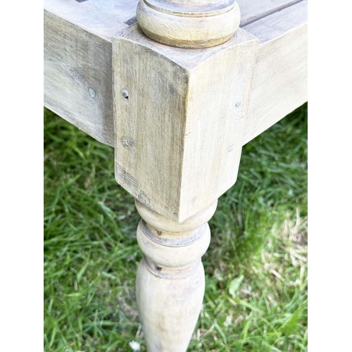 127 - COLONIAL STYLE GARDEN BENCH, weathered teak with inset twin panelled back downswept scroll arms and ... 