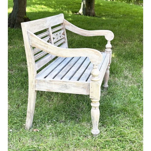 127 - COLONIAL STYLE GARDEN BENCH, weathered teak with inset twin panelled back downswept scroll arms and ... 