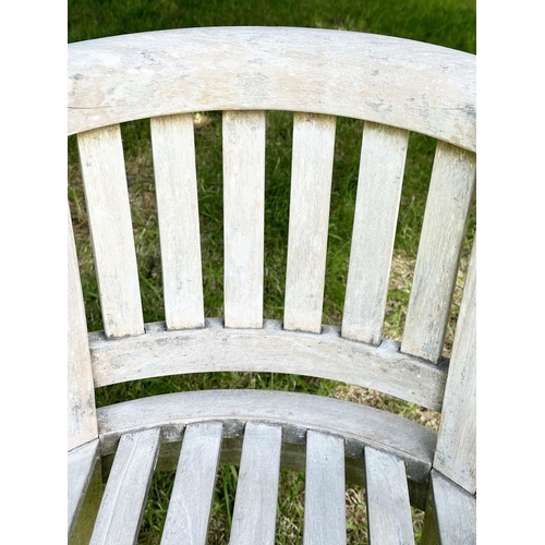 135 - BANANA GARDEN ARMCHAIRS, a pair, well weathered teak with slatted and pegged construction and rounde... 