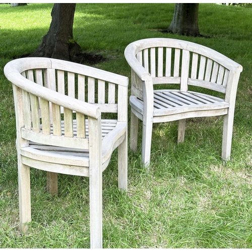 135 - BANANA GARDEN ARMCHAIRS, a pair, well weathered teak with slatted and pegged construction and rounde... 