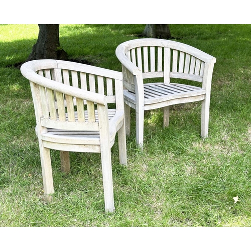 135 - BANANA GARDEN ARMCHAIRS, a pair, well weathered teak with slatted and pegged construction and rounde... 