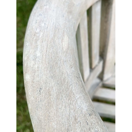 135 - BANANA GARDEN ARMCHAIRS, a pair, well weathered teak with slatted and pegged construction and rounde... 