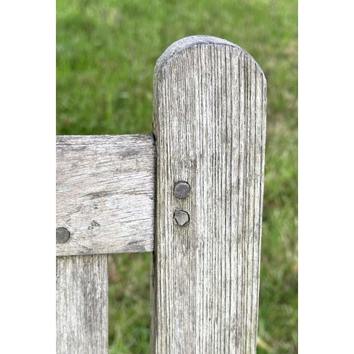 137 - GARDEN BENCH, vintage 'Lister' weathered teak with drop arms and cross slatted seat, 136cm W.