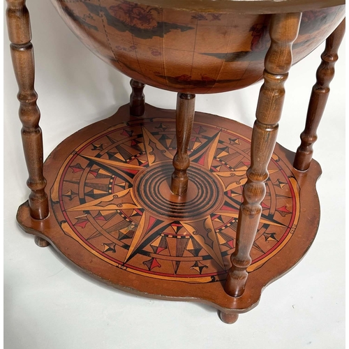 297 - GLOBE COCKTAIL CABINET, in the form of an antique terrestrial globe on stand with rising lid and fol... 