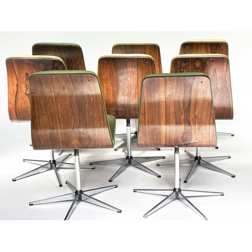 299 - ROBERT HERITAGE CHAIRS, a set of eight, green piped upholstered with veneered curved backs revolving... 