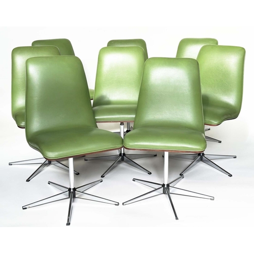 299 - ROBERT HERITAGE CHAIRS, a set of eight, green piped upholstered with veneered curved backs revolving... 