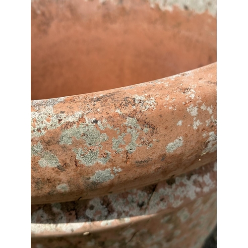 130 - TERRACOTTA GARDEN POT, large weathered terracotta, 58cm H x 67cm W, moulded rim and ridged detail.