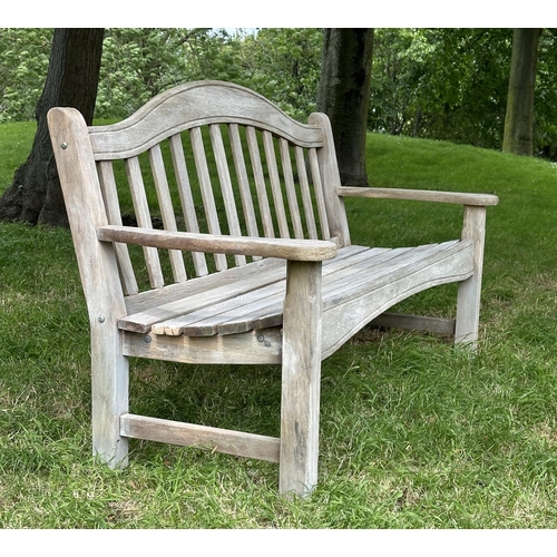 131 - SWAN HATTERSLEY GARDEN BENCH, weathered slatted teak with arched back and flat top shaped arms, 161c... 