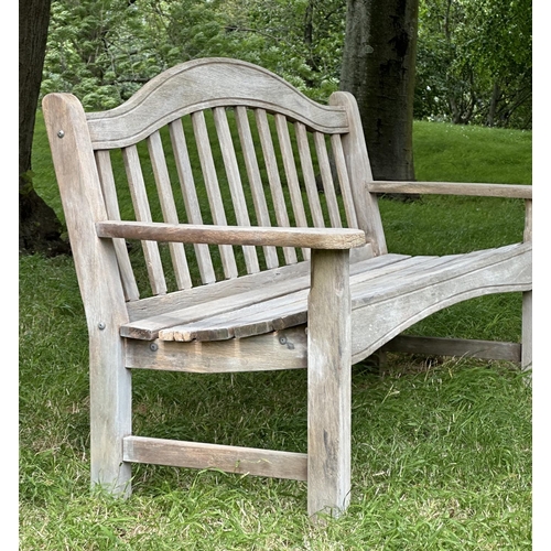 131 - SWAN HATTERSLEY GARDEN BENCH, weathered slatted teak with arched back and flat top shaped arms, 161c... 