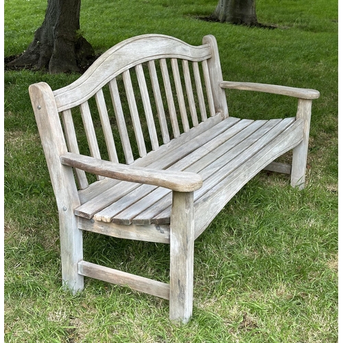 131 - SWAN HATTERSLEY GARDEN BENCH, weathered slatted teak with arched back and flat top shaped arms, 161c... 