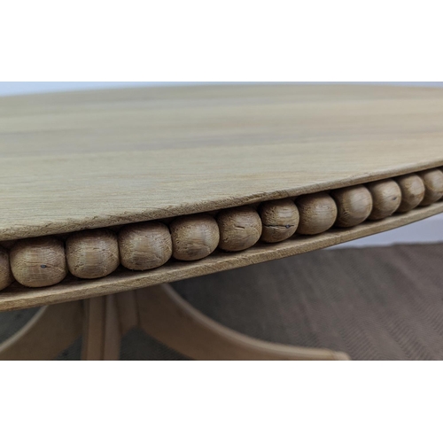 370 - BREAKFAST TABLE, oak circular top with carved detail to side on an outswept quadraform base, 150cm W... 