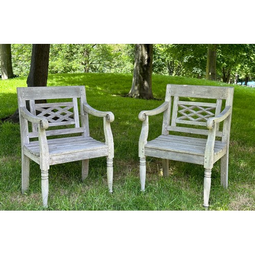 129 - COLONIAL STYLE GARDEN ARMCHAIRS, a pair, nicely weathered high grade teak each with pierced trellis ... 