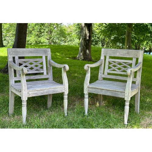 129 - COLONIAL STYLE GARDEN ARMCHAIRS, a pair, nicely weathered high grade teak each with pierced trellis ... 