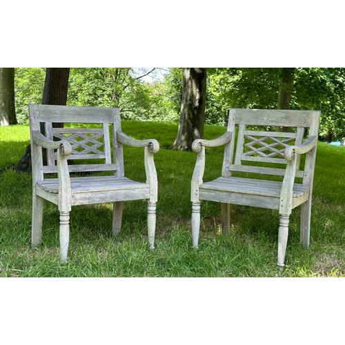 129 - COLONIAL STYLE GARDEN ARMCHAIRS, a pair, nicely weathered high grade teak each with pierced trellis ... 