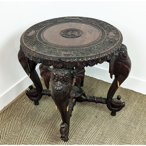 140 - LOW TABLE, early 20th century Indian teak with circular top on elephant carved legs, 62cm H x 74cm W... 