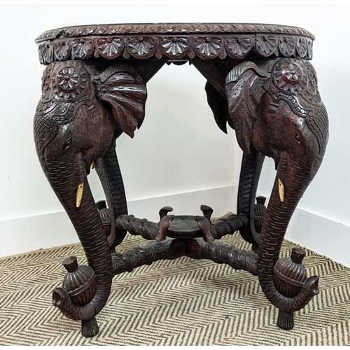 140 - LOW TABLE, early 20th century Indian teak with circular top on elephant carved legs, 62cm H x 74cm W... 