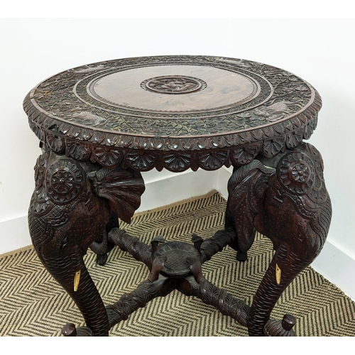 140 - LOW TABLE, early 20th century Indian teak with circular top on elephant carved legs, 62cm H x 74cm W... 