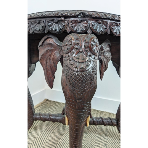 140 - LOW TABLE, early 20th century Indian teak with circular top on elephant carved legs, 62cm H x 74cm W... 