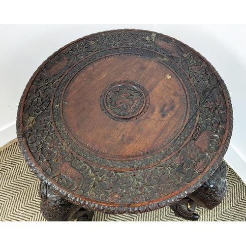 140 - LOW TABLE, early 20th century Indian teak with circular top on elephant carved legs, 62cm H x 74cm W... 