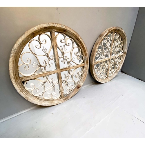 354 - ARCHITECTURAL WALL MIRRORS, a pair, circular, distressed painted frames, 72cm diam. (2)