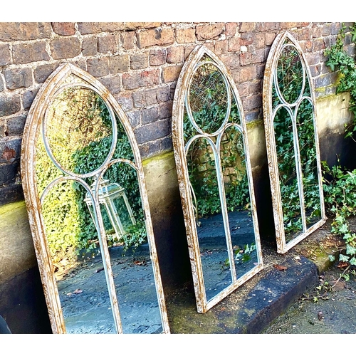 355 - ARCHITECTURAL GARDEN WALL MIRRORS, a set of three, aged metal arched frames, 122cm H x 56ckm W. (3)