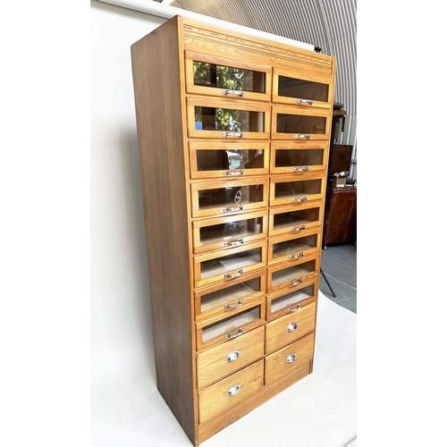 114 - HABERDASHERY CABINET, mid 20th century oak with sixteen glazed drawers above four further drawers, 1... 