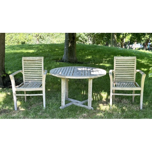 119 - GARDEN ARMCHAIRS, a pair, well weathered teak each stacking with shaped arms together with a circula... 