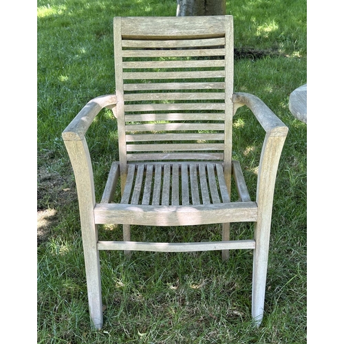 119 - GARDEN ARMCHAIRS, a pair, well weathered teak each stacking with shaped arms together with a circula... 