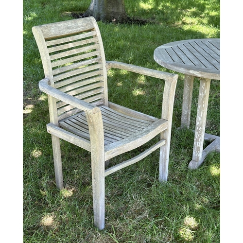 119 - GARDEN ARMCHAIRS, a pair, well weathered teak each stacking with shaped arms together with a circula... 