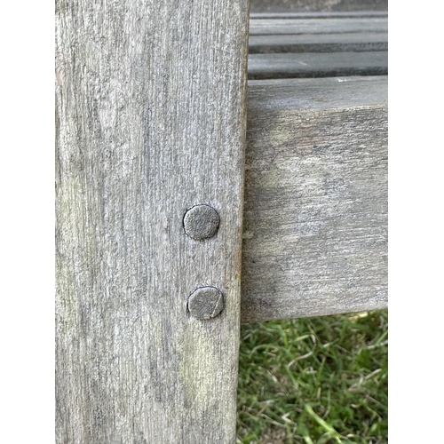 122 - LUTYENS STYLE GARDEN BENCH, well weathered slatted teak after the design by Sir Edwin Lutyens, 165cm... 