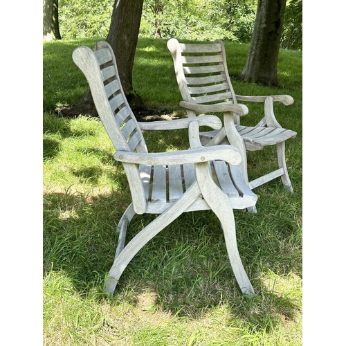 126 - GARDEN ARMCHAIRS BY ALEXANDER ROSE, a pair, weathered teak slatted and folding. (2)