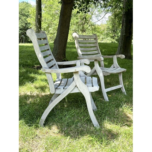 126 - GARDEN ARMCHAIRS BY ALEXANDER ROSE, a pair, weathered teak slatted and folding. (2)