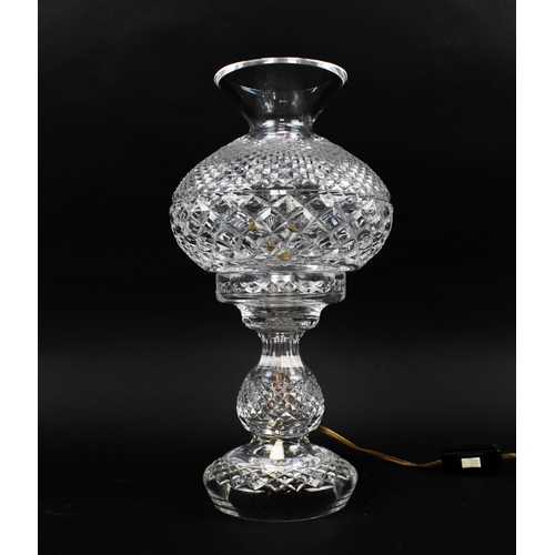 17 - A WATERFORD GLASS TABLE LAMP, with glass shade, together with a Waterford mantel clock. (2)