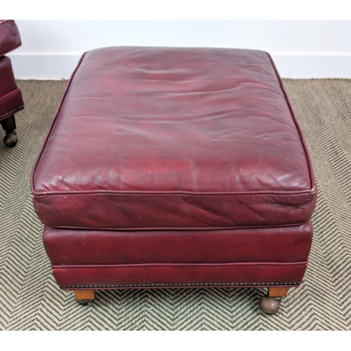 187 - CLUB ARMCHAIR, mid 20th century American red leather, 88cm H x 76cm W and a stool with ball castors,... 