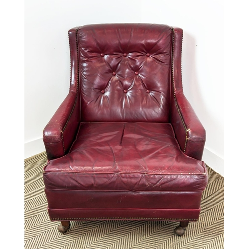 187 - CLUB ARMCHAIR, mid 20th century American red leather, 88cm H x 76cm W and a stool with ball castors,... 