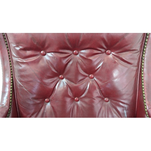 187 - CLUB ARMCHAIR, mid 20th century American red leather, 88cm H x 76cm W and a stool with ball castors,... 