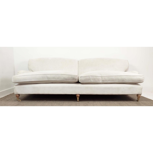 219 - SOFA, Howard style in white upholstery with turned feet and brass castors, 79cm H x 228cm W x 100cm ... 