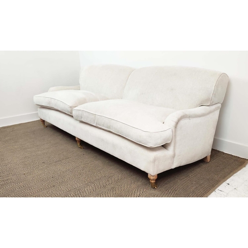 219 - SOFA, Howard style in white upholstery with turned feet and brass castors, 79cm H x 228cm W x 100cm ... 