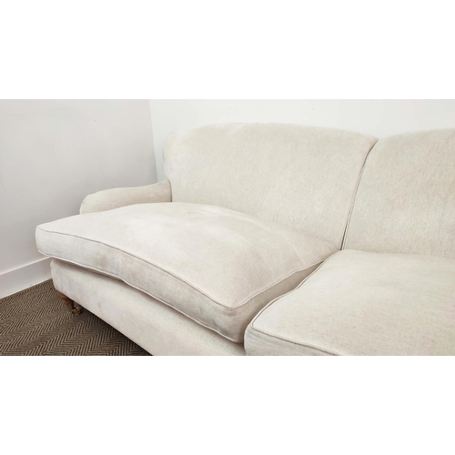 219 - SOFA, Howard style in white upholstery with turned feet and brass castors, 79cm H x 228cm W x 100cm ... 